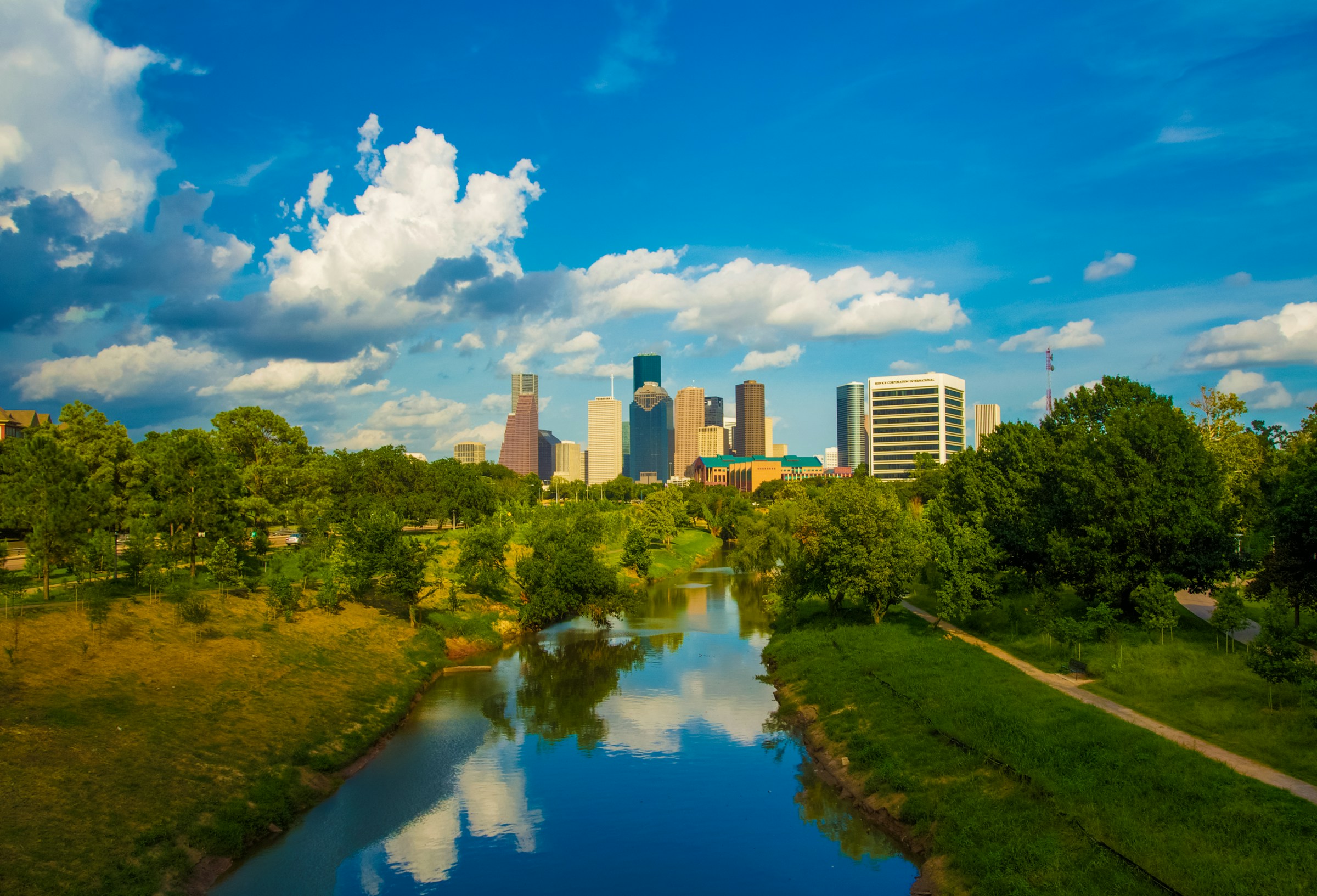 The Houston skyline beyond Buffalo Bayou and its green banks