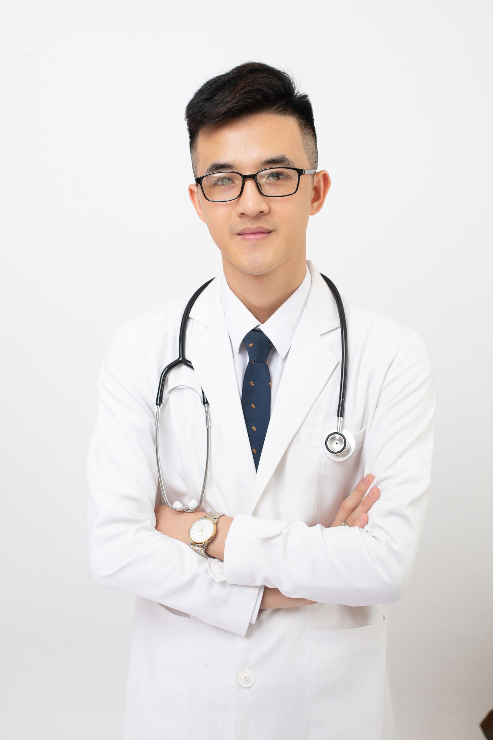 Portrait of a young Asian clinician in a white coat and tie